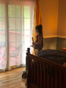 Girl vacuuming a bedroom